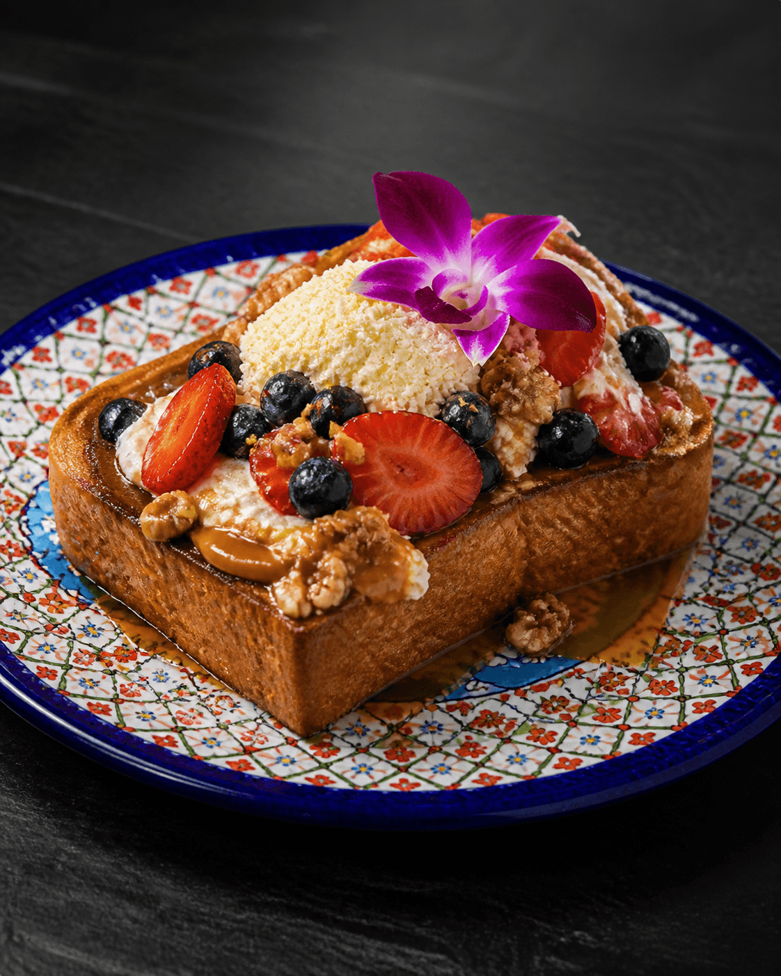 Casa Mia Bistro Fancy 3 Leche Toast with strawberries, blueberries, walnuts, and cream